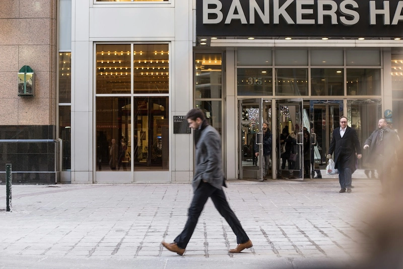 A young man walking on the streets of The Loop, a Chicago neighborhood.